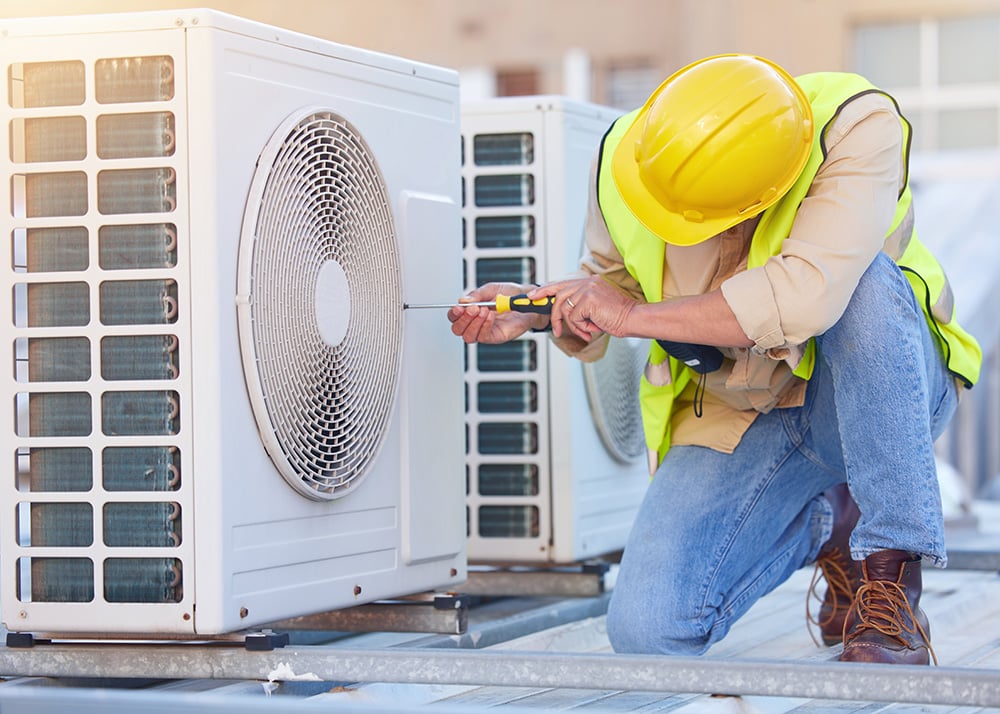 A person fixing a HVAC system